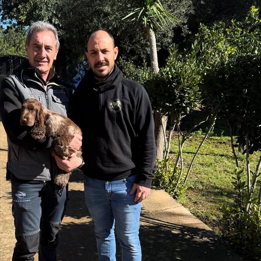 A family collecting their Cocker Spaniel puppy