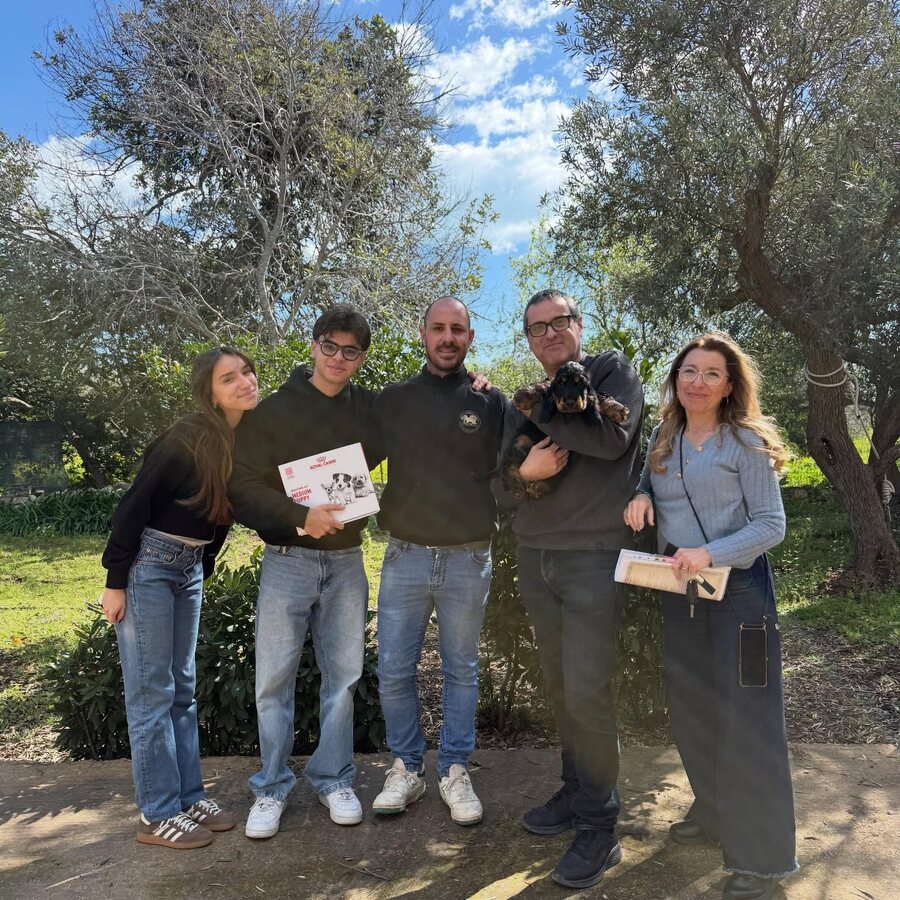 A family collecting their Cocker Spaniel puppy